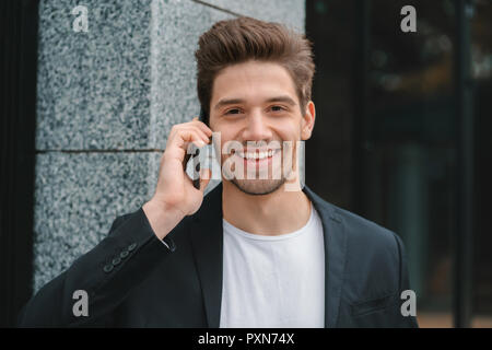 Close up portrait of businessman have conversation using mobile phone. Business guy in formal suit gladly talks with colleague. Office employee, wage worker, weekdays concept Stock Photo