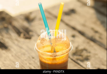 Fresh juice in a plastic cup with two straws Stock Photo