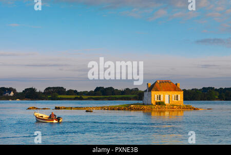 France, Brittany, Morbihan, Belz, Etel river, St. Cado, house on the island of Nichtarguer with fisherman in boat Stock Photo