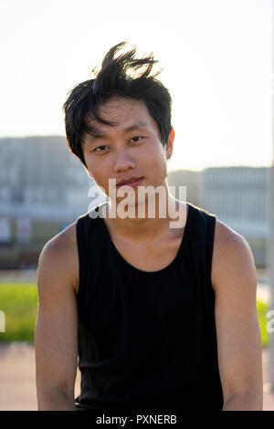 Portrait of confident young man outdoors at sunset Stock Photo