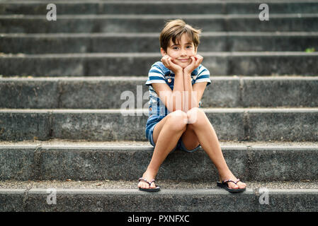 Portrait of relaxed little girl sitting on stairs