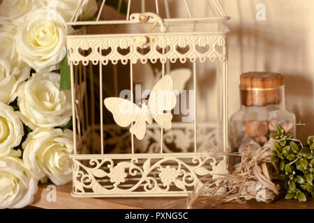 set of decoration with white metal cage and flowers Stock Photo