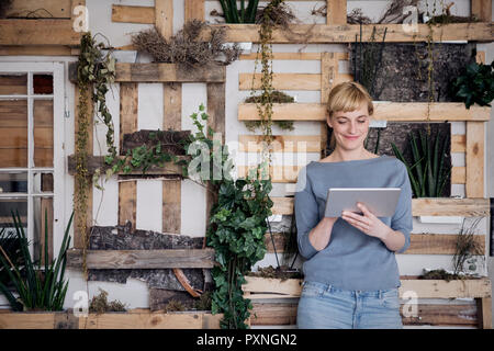 Smiling woman using tablet Stock Photo