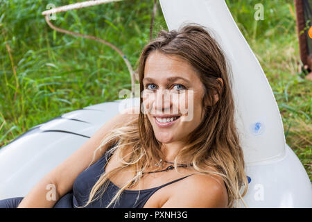 Portrait of smiling woman in inflatable pooltoy Stock Photo