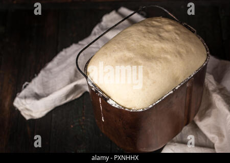 dough rises in the bowl, top view Stock Photo