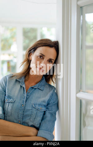 Portrait of smiling mature woman at home Stock Photo