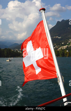 Switzerland, blowing Swiss flag of boat on Lake Lugano, close-up Stock Photo