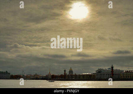 The dark sky over the city.The sun shines through the clouds. Stock Photo