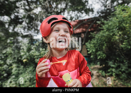 Portrait of laughing masqueraded little girl having fun Stock Photo