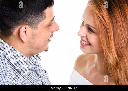Young Hispanic couple smiling and looking at each other in love Stock Photo