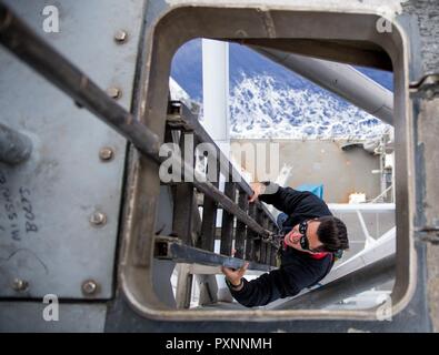 8 PACIFIC OCEAN (June 8, 2016) Electronics Technician 3rd Class Billy Kiakotos, from Brooklyn, N.Y., goes aloft on the midship mast for preventative maintenance aboard the Ticonderoga-class guided-missile cruiser USS Princeton (CG 59). Princeton is currently underway as part of the Nimitz Carrier Strike Group on a regularly scheduled deployment for the Western Pacific and Indian Oceans. Stock Photo