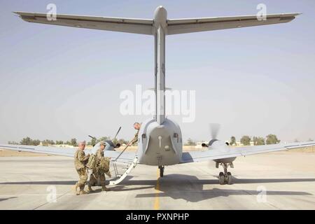 U.S. Army Maj. Gen. Flem Walker, commanding general, 1st Sustainment Command (Theater) and the deputy commanding general-sustainment for United States Army Central, boards a C-12 Huron at Camp Taji, Iraq, June 17, 2017. The purpose of Walker's visit was to get an overview of the U.S. Army Logistic capability after taking command on May 15, 2017. His visit will assist in increasing partner forces capability as an integral part of the Combined Joint Task Force – Operation Inherent Resolve building partner capacity mission by training and improving the capability of partnered forces fighting ISIS Stock Photo