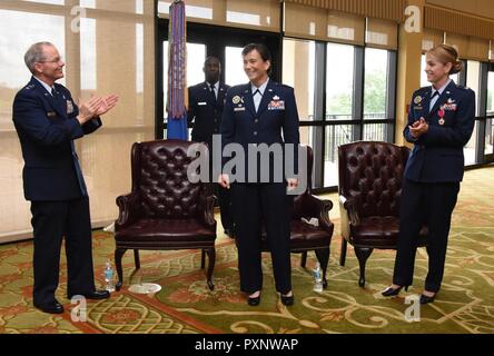 Maj. Gen. Bob LaBrutta, 2nd Air Force commander, and Col. Michele Edmondson, outgoing 81st Training Wing commander, applaud for Col. Debra Lovette, 81st TRW commander, as she assumed command during a change of command ceremony at the Bay Breeze Event Center June 2, 2017, on Keesler Air Force Base, Miss. The ceremony is a symbol of command being exchanged from one commander to the next by the handing-off of a ceremonial guidon. Stock Photo