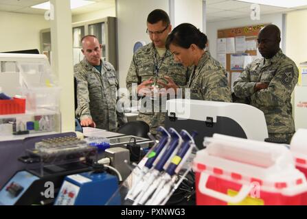 Capt. Mauricio De Castro Pretelt, 81st Medical Operations Squadron clinical and molecular geneticist, briefs Col. Debra Lovette, 81st Training Wing commander, on genetics laboratory capabilities and procedures during an 81st Medical Group orientation tour in the Keesler Medical Center June 16, 2017, on Keesler Air Force Base, Miss. The purpose of the tour was to familiarize Lovette with the group’s mission, operations and personnel. Stock Photo