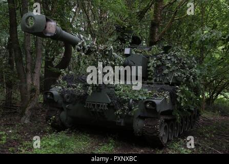 An M109A6 Paladin self-propelled howitzer with Battery C, 3rd Battalion, 29th Field Artillery Regiment, 3rd Armored Brigade Combat Team, 4th Infantry Division, operates in a hide site during a combat training center rotation as part of Combined Resolve VIII at Hohenfels Training Area, Germany, June 12, 2017. While training in support of Operation Atlantic Resolve, the 'Pacesetters' Battalion has adopted 'hide and seek' tactics to fight a near-peer adversary, concealing artillery then popping out to to fire at targets. Stock Photo