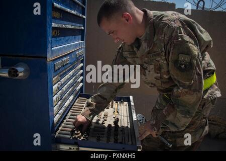 U.S. Air Force Master Sgt. Daniel Hose, the NCOIC of vehicle maintenance assigned to the 442nd Air Expeditionary Squadron, retrieves tools from a tool box at Baghdad Diplomatic Support Center, Iraq, June 5, 2017. Daniel and his brother Master Sgt. Scott Hose are both deployed to Iraq in support of Combined Joint Task Force -Operation Inherent Resolve. CJTF-OIR is the global Coalition to defeat ISIS in Iraq and Syria. Stock Photo