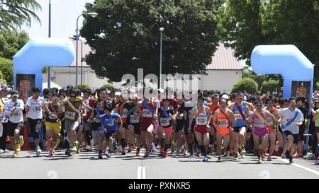 Competitors start running the main event, the Ekiden at Yokota Air Base, Japan, June 4, 2017. An Ekiden is a Japanese long distance relay that consists of teams of runners covering a certain distance. The Yokota Ekiden is 20K in distance made up of four runners each running a 5K. Stock Photo