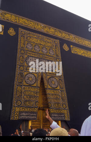 MAKKAH - CIRCA 2013 : A close up view of kaaba door and the kiswah (cloth that covers the kaaba) at Masjidil Haram  in Makkah, Saudi Arabia. The door  Stock Photo