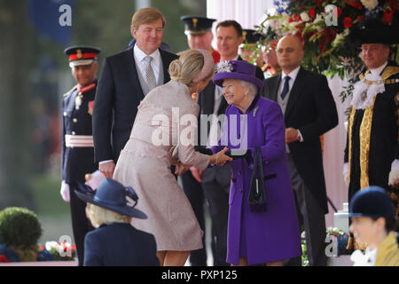 Queen Elizabeth II greets Queen Maxima of the Netherlands as King Willem-Alexander looks on during their ceremonial welcome at Horse Guards Parade in London. Stock Photo
