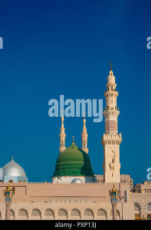 Exterior view of minarets and green dome of a mosque taken off the compound.masjid Al Nabawi minaret and green dome in Madinah, Saudi Arabia Stock Photo