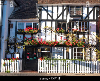 Friends Restaurant in Pinner High Street, Middlesex UK. Restaurant is located in historic timber tudor building. Red geraniums are growing outside. Stock Photo