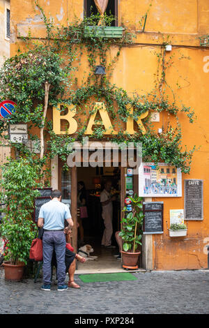 A colourful bar on the corner of  Vicolo Del Cinque in the Trastevere district of Rome, central Italy. Stock Photo