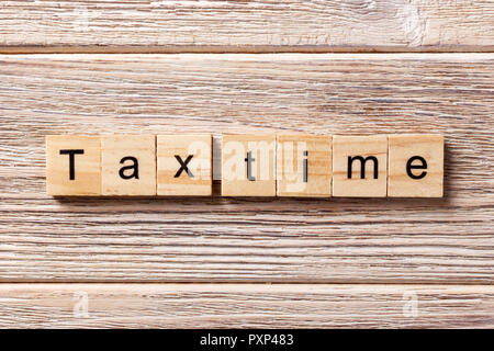 tax time word written on wood block. tax time text on table, concept. Stock Photo