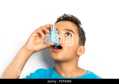 A black Boy using an asthma inhaler Stock Photo
