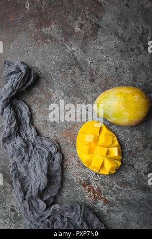 Fresh mango tropical fruits over gray background, top view with Copy space. Stock Photo