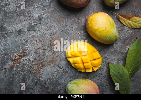 Fresh mango tropical fruits over gray background, top view with Copy space. Stock Photo