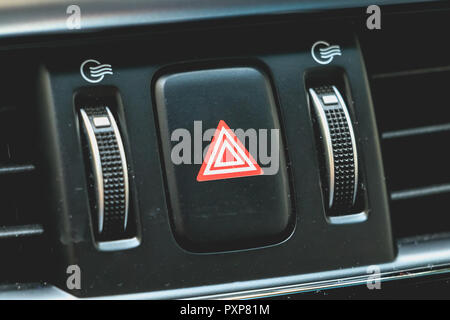 car emergency light button on a modern dashboard. Car interior details Stock Photo