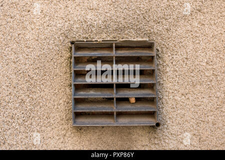 old metal ventilation grid on traditional british house wall outside. Stock Photo