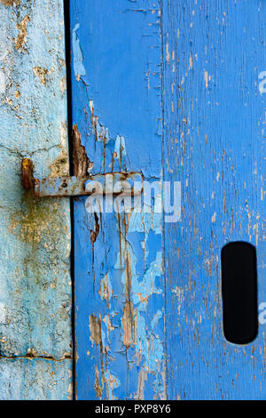 Old paint on a window and a door in blues and white Stock Photo