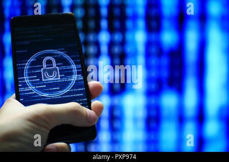 hand hold mobile phone flow. padlock icon symbolize security and motion movement of blue binary code computer data moving in the background. Stock Photo
