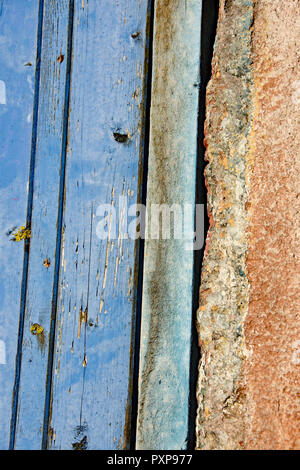 Old paint on a window and a door in blues and white Stock Photo