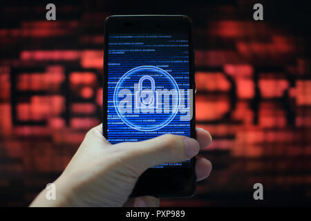 system integrity working while other pass down. hand holding mobile phone with padlock icon on blue binary code screen. Error message in computer. Stock Photo