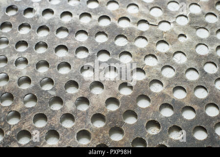 old steel sheet with circular perforations. Stock Photo