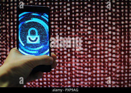 system integrity working while other pass down. hand holding mobile phone with padlock icon on blue binary code screen. Error message in computer. Stock Photo