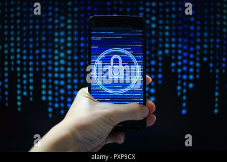 hand hold mobile phone flow. padlock icon symbolize security and motion movement of blue binary code computer data moving in the background. Stock Photo