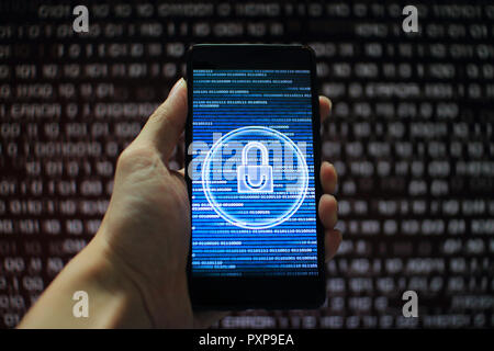 system integrity working while other pass down. hand holding mobile phone with padlock icon on blue binary code screen. Error message in computer. Stock Photo