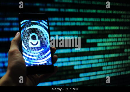 hand hold mobile phone flow. padlock icon symbolize security and motion movement of blue binary code computer data moving in the background. Stock Photo