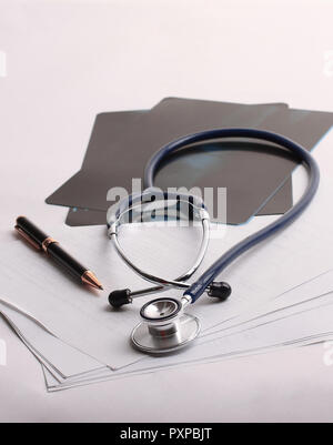 stethoscope,x-ray and pen on the table. photo with copy space Stock Photo