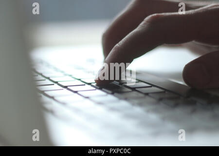close up. blurred image of male typing on laptop keyboard Stock Photo