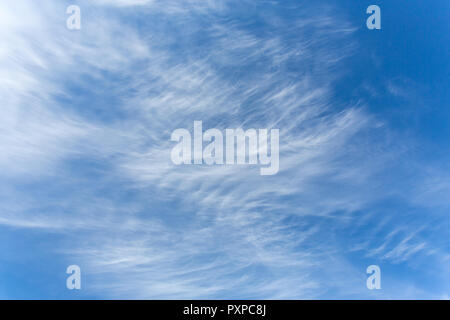 Beautiful blue sky with whispy lines of white clouds - cirrus or mares tails Stock Photo