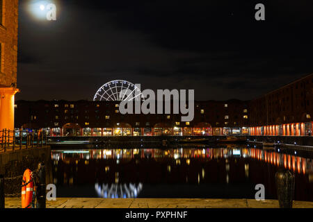 The rising Moon over Albert Dock, Liverpool, Ferris Wheel in background. Image taken in October 2018. Stock Photo