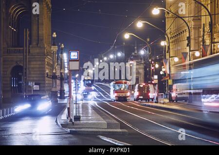 Traffic of trams and cars on the city street at night. Prague, Czech Republic. Stock Photo