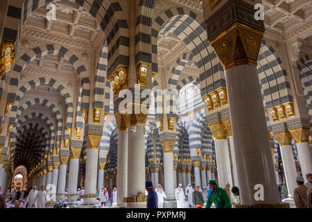 AL MADINA, SAUDI ARABIA-CIRCA 2014: Interior view of Masjid Nabawi (Nabawi mosque) and Muslim men in Al Medina, Kingdom os Saudi Arabia. Stock Photo