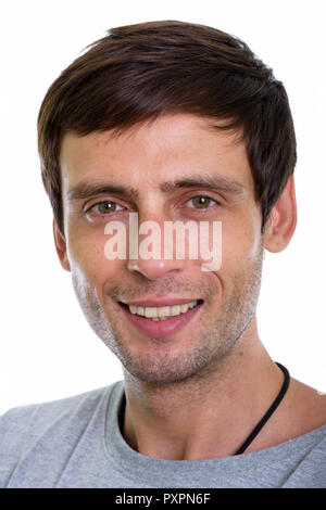 Studio shot of face of happy young handsome man smiling Stock Photo