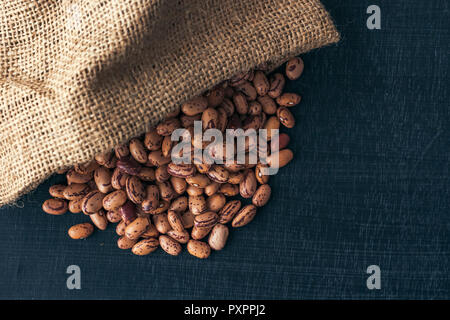 Pinto beans in burlap sack, healthy legume beans, selective focus Stock Photo