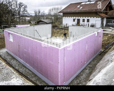 Prefabricated house, workers in setting up the basement walls Stock Photo